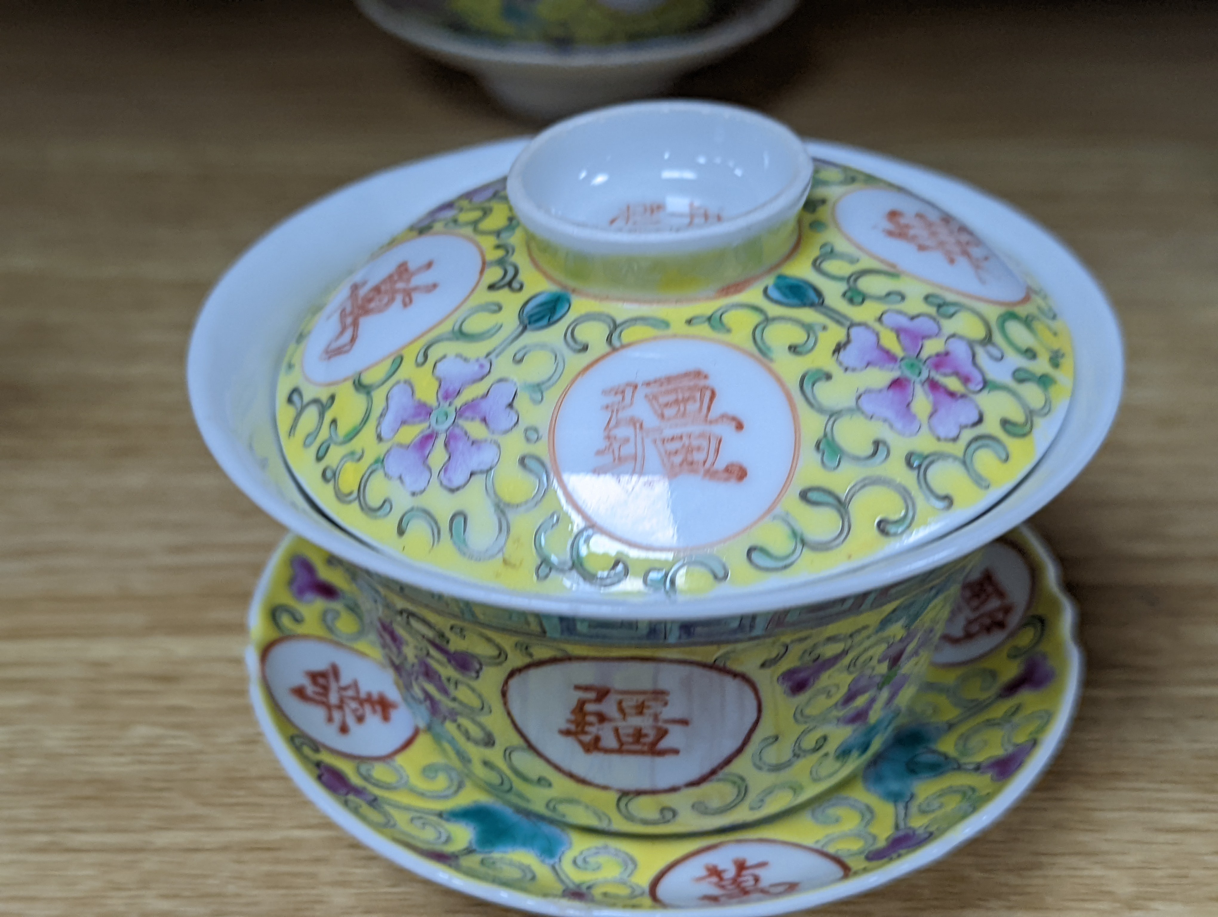 A pair of Chinese enamelled porcelain rice bowls, covers and stands and an odd bowl